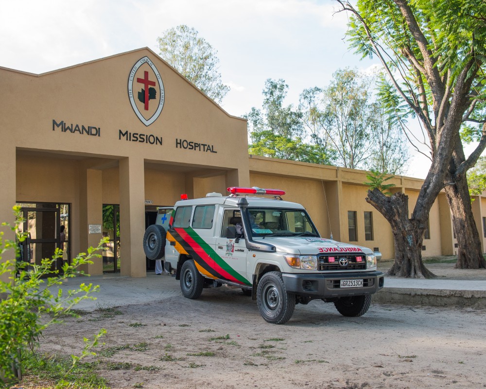 Photo of Mwandi Mission Hospital with ambulance out front
